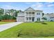 Two-story light blue house with gray roof, two-car garage, and landscaped yard at 4041 Oxeye Loop, Johns Island, SC 29455