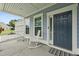Front porch with rocking chairs and entryway to two story home at 4041 Oxeye Loop, Johns Island, SC 29455