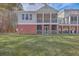 Two-story home with screened porch and grassy backyard at 4816 8Th Tee Dr, Hollywood, SC 29449