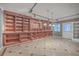 Large basement room with built-in shelving and tile flooring at 4816 8Th Tee Dr, Hollywood, SC 29449