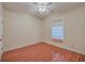 Bright bedroom with hardwood floors and ceiling fan at 4816 8Th Tee Dr, Hollywood, SC 29449