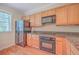Modern kitchen with wood cabinets, granite countertops, and black appliances at 4816 8Th Tee Dr, Hollywood, SC 29449