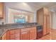 Kitchen with granite countertops, wood cabinets, and a view to the living room at 4816 8Th Tee Dr, Hollywood, SC 29449