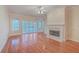 Living room with hardwood floors, fireplace, and access to balcony at 4816 8Th Tee Dr, Hollywood, SC 29449