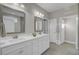 Double vanity bathroom with white cabinets and a large mirror at 482 Hidden Meadow Ln, Summerville, SC 29486