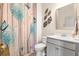 Modern bathroom with updated vanity, toilet, and decorative shower curtain at 531 Switchgrass Dr, Summerville, SC 29486