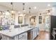 Modern kitchen with large island, stainless steel appliances, and hardwood floors at 531 Switchgrass Dr, Summerville, SC 29486