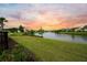Peaceful lake view with lush green grass and neighborhood homes at 531 Switchgrass Dr, Summerville, SC 29486