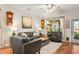 Spacious living room featuring hardwood floors, comfortable seating, and large windows at 531 Switchgrass Dr, Summerville, SC 29486