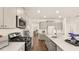 Modern kitchen with gray cabinets, quartz countertops, and stainless steel appliances at 569 Richfield Way, Summerville, SC 29486