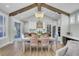 Bright dining area with a large wooden table and chairs, under exposed beams at 711 Blueway Ave, Summerville, SC 29486