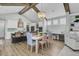 Open dining area with a large wooden table and chairs, exposed beams, and kitchen views at 711 Blueway Ave, Summerville, SC 29486