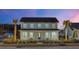 Two-story light blue house with front porch, landscaping, and palm trees at 711 Blueway Ave, Summerville, SC 29486