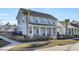 Two-story light blue house with front porch, landscaping, and palm trees at 711 Blueway Ave, Summerville, SC 29486
