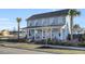 Two-story light blue house with front porch, landscaping, and palm trees at 711 Blueway Ave, Summerville, SC 29486