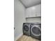 Laundry room with washer, dryer and white cabinets at 711 Blueway Ave, Summerville, SC 29486