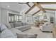 Open living space with vaulted ceiling, exposed beams, and a large sectional sofa at 711 Blueway Ave, Summerville, SC 29486
