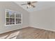 Bright bedroom with wood-look floors and large window at 7936 Vermont Rd, North Charleston, SC 29418