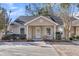 Tan colored house with white trim and small front porch at 7936 Vermont Rd, North Charleston, SC 29418