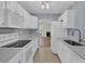 White kitchen with gray countertops and stainless steel appliances at 7936 Vermont Rd, North Charleston, SC 29418