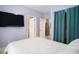 Bedroom with white bedding, TV and teal curtains at 882 Sedge Ct, Charleston, SC 29412