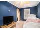 Blue bedroom with twin bed and access to a small room at 882 Sedge Ct, Charleston, SC 29412