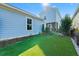 Artificial turf backyard with blue house and pergola at 103 Green Grass Rd, Summerville, SC 29483