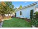 Artificial turf backyard with blue house and fence at 103 Green Grass Rd, Summerville, SC 29483