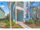 Front view of charming two-story light blue house with porch at 103 Green Grass Rd, Summerville, SC 29483