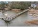 Aerial view of a house with two wooden docks extending into the water at 1034 Bradbury Ln, Charleston, SC 29492