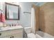 Clean bathroom with a single sink, tub, and neutral tile finishes at 1034 Bradbury Ln, Charleston, SC 29492