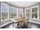 Bright dining room with a farmhouse table and large windows at 1034 Bradbury Ln, Charleston, SC 29492