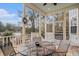 Screened porch with metal table and chairs, offering scenic views at 1034 Bradbury Ln, Charleston, SC 29492