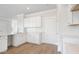 White kitchen features hardwood floors and stainless steel appliances at 114 Lilac Grove Way, Summerville, SC 29486