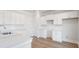 Modern kitchen with white cabinets, quartz countertops, and stainless steel appliances at 114 Lilac Grove Way, Summerville, SC 29486