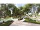 Landscaped walking path with benches and lush greenery at 116 Lilac Grove Way, Summerville, SC 29486