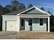 Charming craftsman style home with a light blue exterior, white trim, and a two-car garage at 116 Lilac Grove Way, Summerville, SC 29486