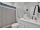 Clean bathroom with white vanity and striped shower curtain at 117 Upper Trestles Ave, Summerville, SC 29483