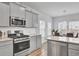Modern kitchen featuring stainless steel appliances and gray cabinets at 117 Upper Trestles Ave, Summerville, SC 29483