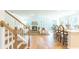 Open concept kitchen with island and hardwood floors. View of living room and stairs at 126 Lilac Grove Way, Summerville, SC 29486
