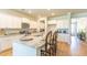 Bright kitchen with white cabinets, granite countertops and island with seating at 126 Lilac Grove Way, Summerville, SC 29486