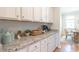 White cabinets and granite countertops in this kitchen with butler's pantry at 126 Lilac Grove Way, Summerville, SC 29486