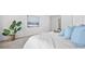 Main bedroom with king-size bed, soft blue pillows, and a large window at 129 Lilac Grove Way, Summerville, SC 29486