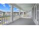 Spacious porch overlooking the community with grey flooring and white railings at 129 Lilac Grove Way, Summerville, SC 29486