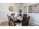 Dining room with dark wood table, six chairs, and decorative wall art at 132 Lilac Grove Way, Summerville, SC 29486