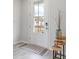 Bright entryway with a white door, wood-look floors and simple decor at 132 Lilac Grove Way, Summerville, SC 29486