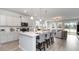 Open kitchen with white cabinets, island seating, and stainless steel appliances at 132 Lilac Grove Way, Summerville, SC 29486