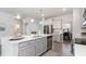 Open kitchen with island, stainless steel appliances, and white cabinets at 132 Lilac Grove Way, Summerville, SC 29486