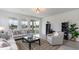 Living room with light-colored sofas, a coffee table, and an open floor plan at 132 Lilac Grove Way, Summerville, SC 29486