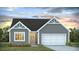 Gray exterior boasts a charming two-car garage and attractive landscaping at 136 Lilac Grove Way, Summerville, SC 29486